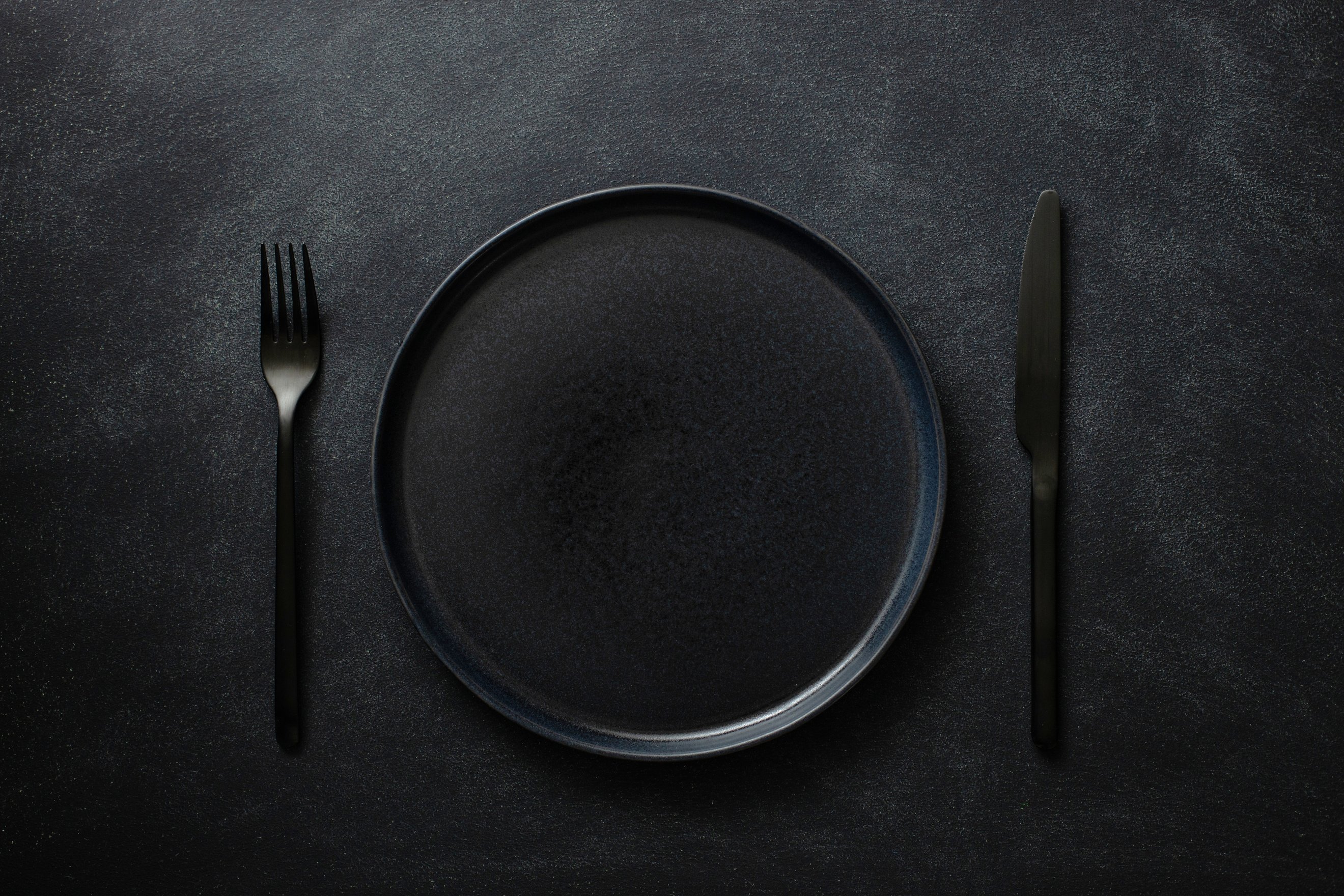 Empty Black Plate with Cutlery